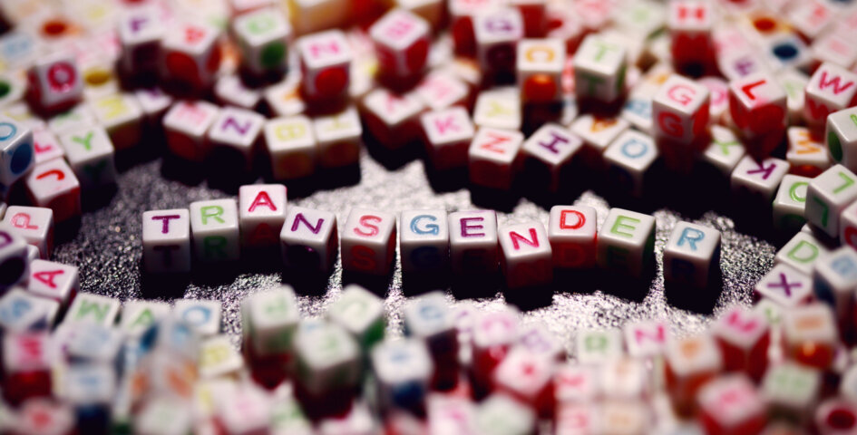 Cubes with colorful letters spelling out “transgender”