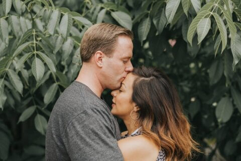 A couple in front of a tree.